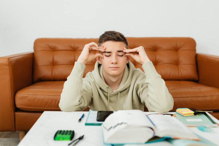 a young man with his hands on head